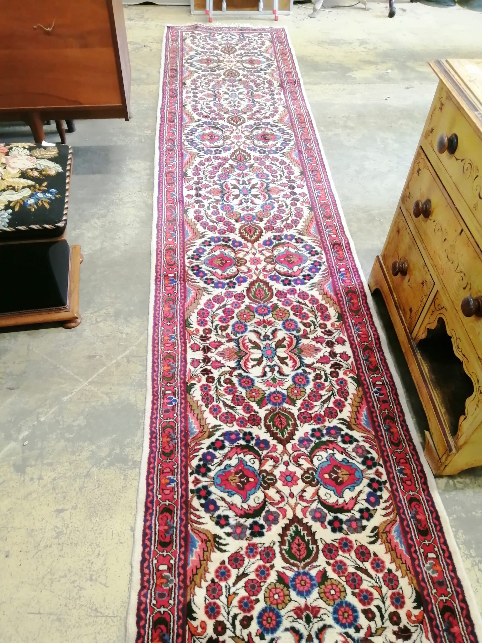 A Persian cream ground runner with central foliate motifs, 400 x 86cm